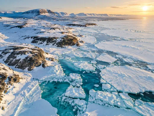 Turquoise water between broken sea ice